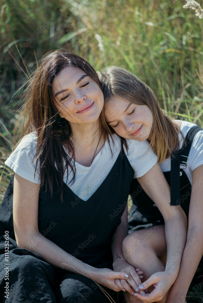 Young mother and daughter teenager in nature Young mother and daughter teenager in nature