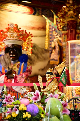 A close-up of the statue of Zhongtian Yuanshuai, commonly known as Nezha, revered as the leader of the Five Generals, often placed centrally in Taiwanese temples to protect and oversee the community. photo