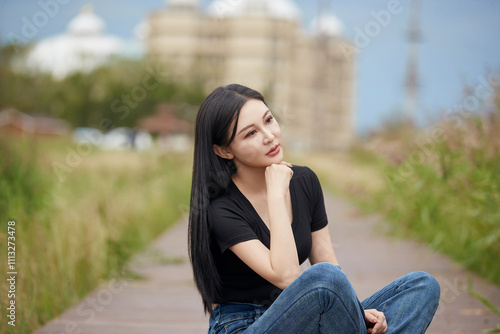 Beautiful women taking photos in the grassland wetland park in midsummer