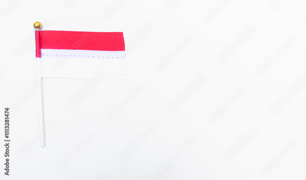 Indonesian flag on white pole isolated on white background. The mini flag flutters in the hand Indonesian flag on white pole isolated on white background. The mini flag flutters in the hand