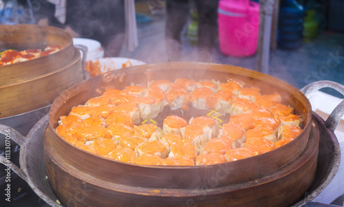 Dimsum with various flavors in bamboo steamer. Dim sum with mentai sauce is being steamed in a wooden pot, street food dim sum at market photo