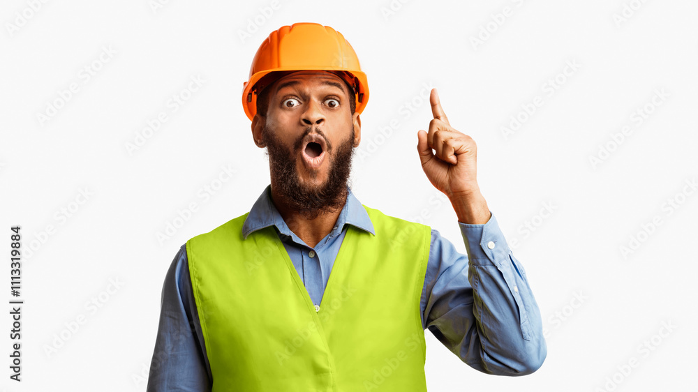 Great Idea. Black Builder Worker Pointing Finger Up Having Plan Posing On White Studio Background. Panorama Great Idea. Black Builder Worker Pointing Finger Up Having Plan Posing On White Studio Background. Panorama
