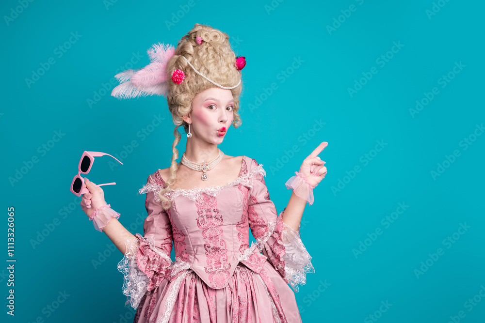 Fototapeta premium Photo of young woman direct finger empty space wear renaissance queen costume isolated on teal color background