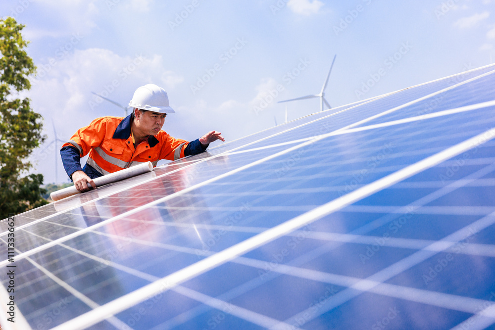 Engineer checking the activity of solar panels Engineer checking the activity of solar panels