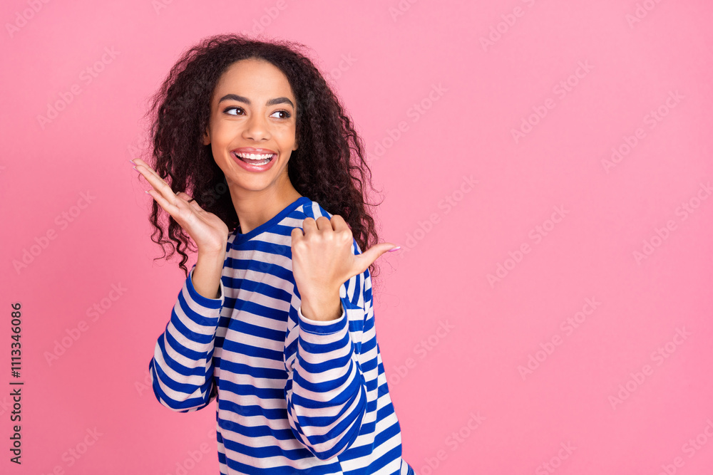 Portrait of nice young girl indicate finger empty space wear striped pullover isolated on pink color background Portrait of nice young girl indicate finger empty space wear striped pullover isolated on pink color background