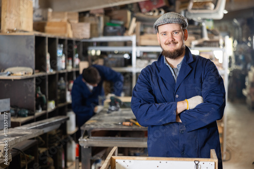 Portrait of experienced carpenter of furniture factory in the production workshop