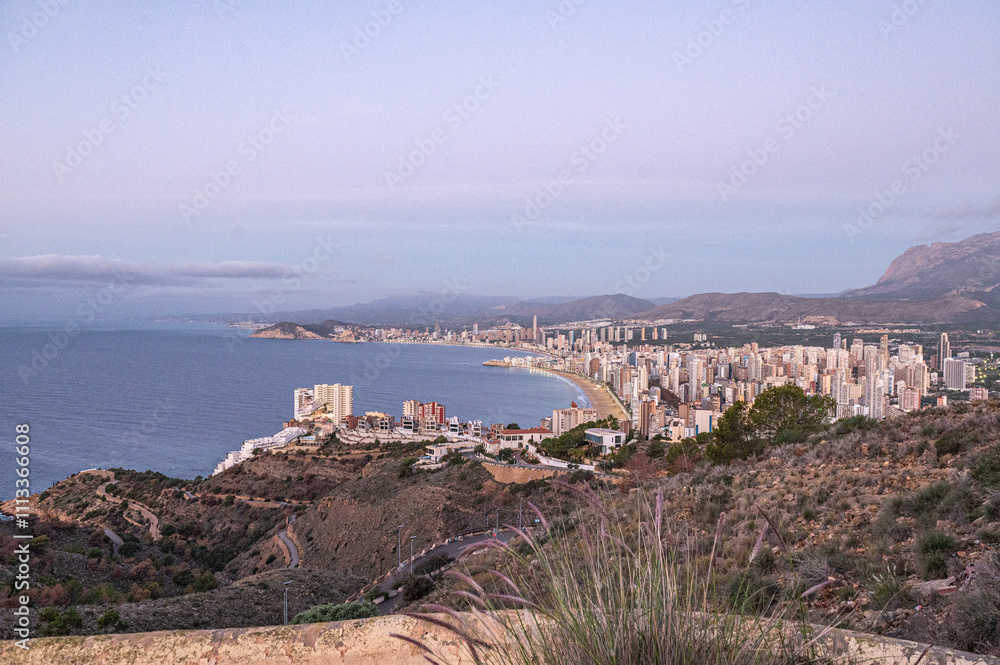 Panorama in the Sunrise on a clear day over Benidorm in Spain from the Mirador de la Cruz.