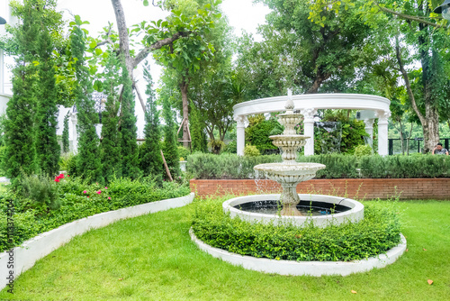 Outdoor water fountain multi-tiered in the park,The three tiered fountain in english garden. photo