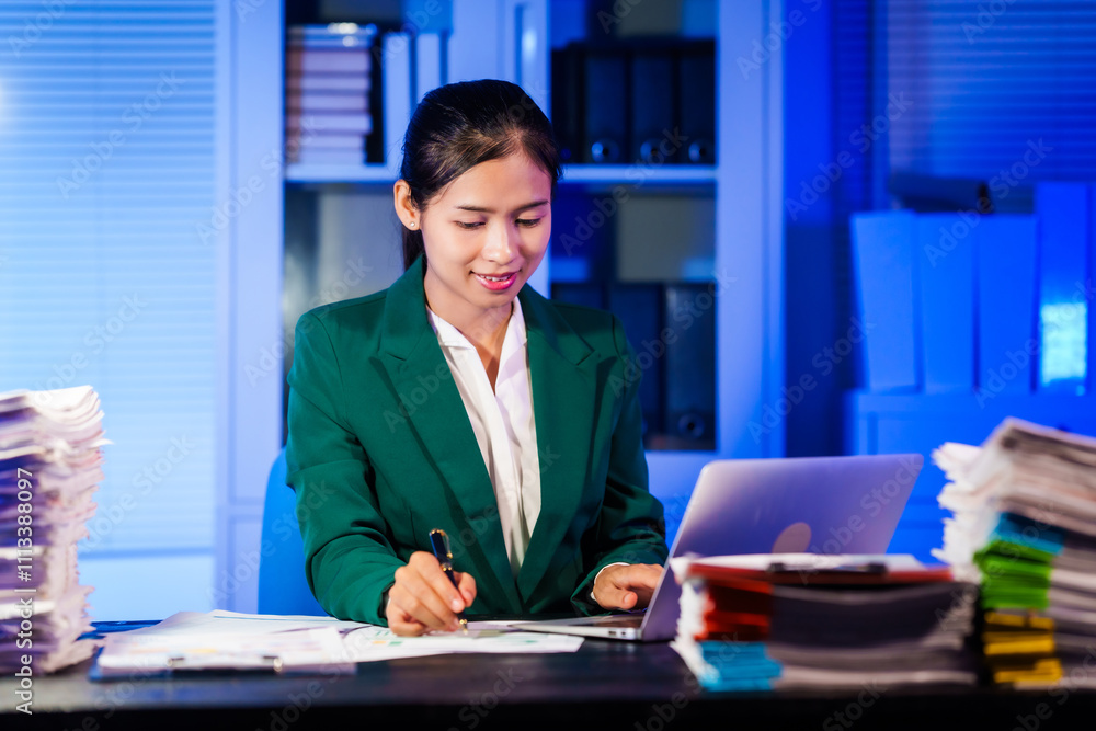 An Asian businesswoman works overtime,sitting at her desk at night, searching through numerous documents on her PC or laptop.Facing office problems,she also chats online while handling lots of work An Asian businesswoman works overtime,sitting at her desk at night, searching through numerous documents on her PC or laptop.Facing office problems,she also chats online while handling lots of work
