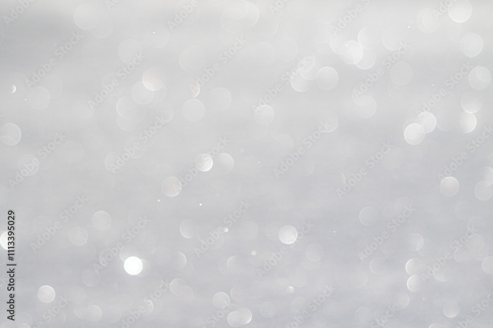 Blurred white bokeh background, snow sparkles in the sun Blurred white bokeh background, snow sparkles in the sun