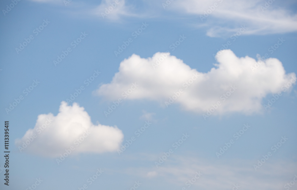 White cumulus clouds look large against the blue sky. White cumulus clouds look large against the blue sky.