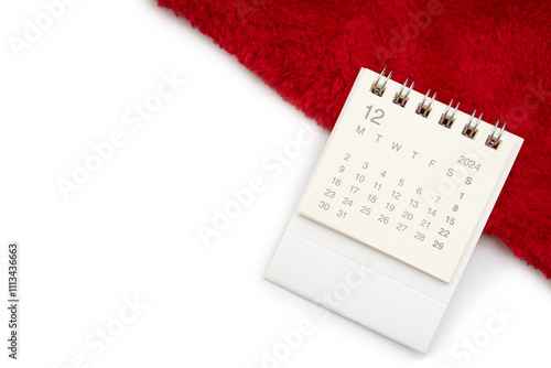 Simple desk calendar for DECEMBER 2024 with Santa hats on white background. New year Calendar concept with copy space. 2024 DEC calendar. photo