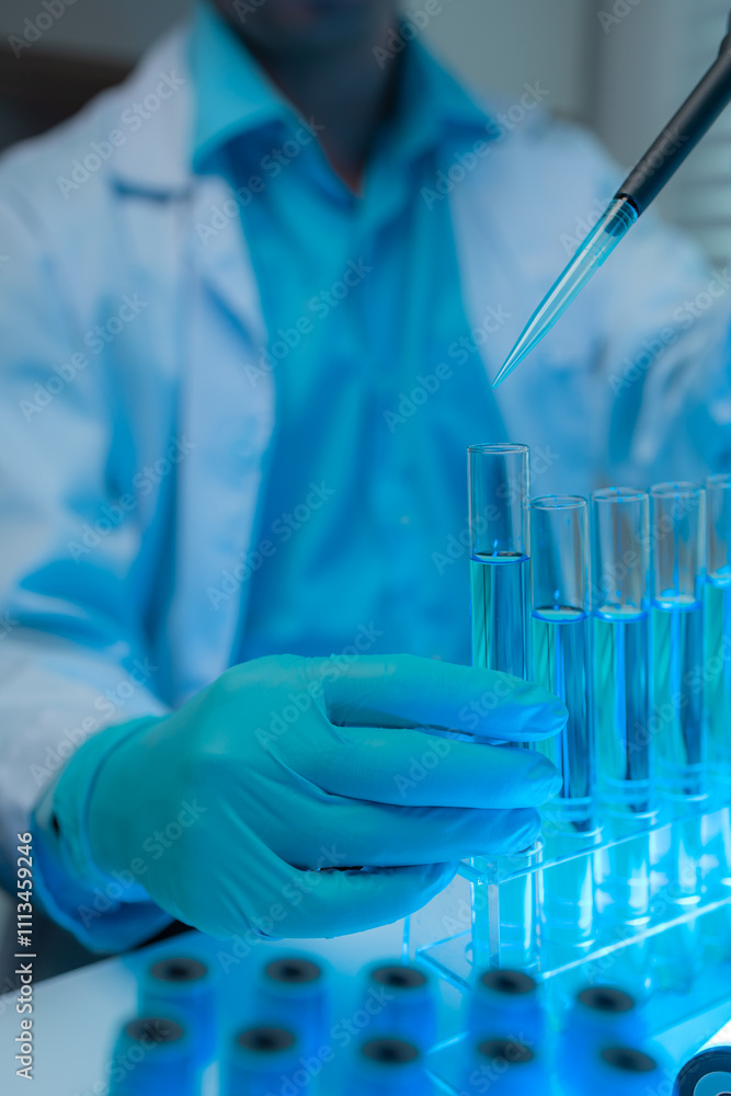 Fototapeta premium a scientist works comfortably in a familiar environment in a laboratory, a scientific researcher is studying a liquid substance for a report, test tube, chemical, medicine