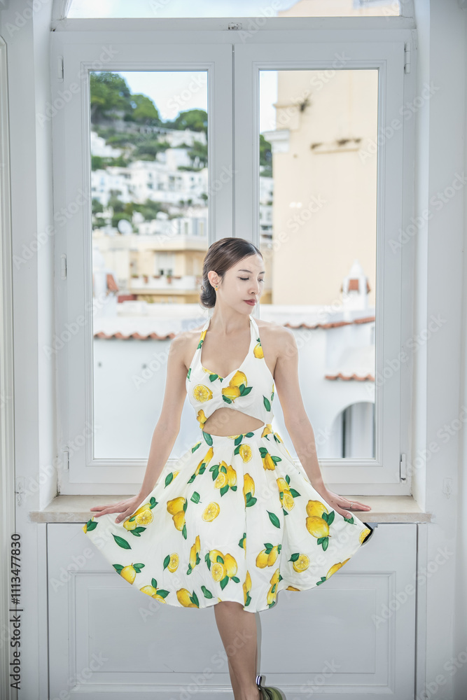 Woman in beautiful dress near the window in home. Happy morning in Italy. Woman in beautiful dress near the window in home. Happy morning in Italy.