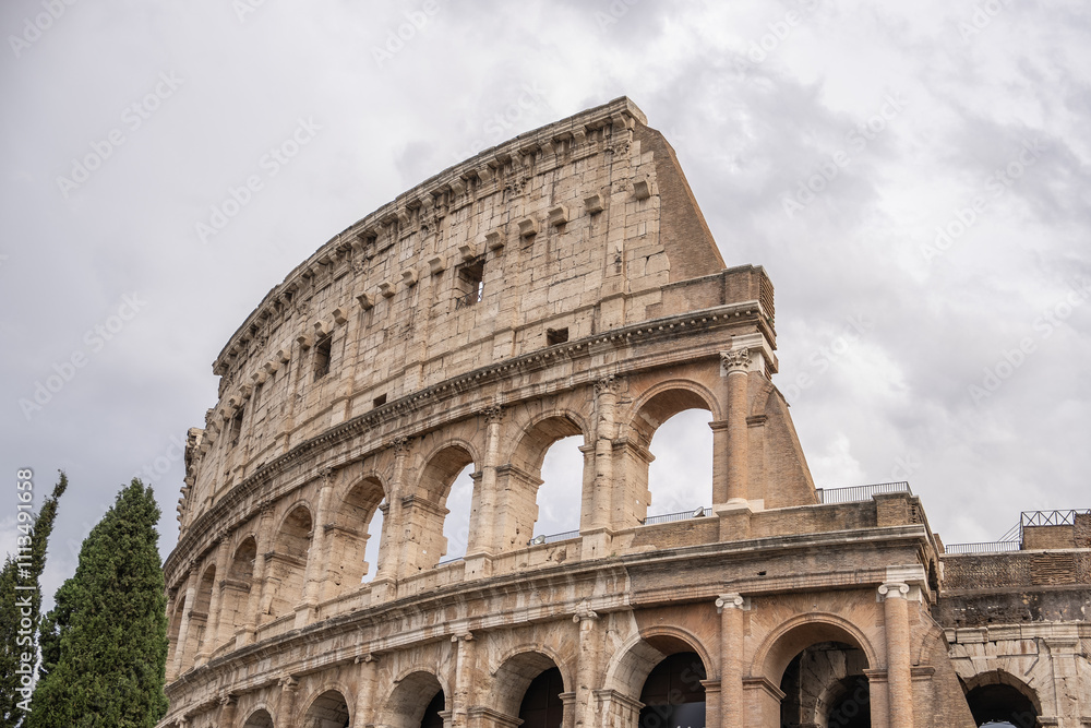 Obraz premium Arches archictecture of Colosseum (Colosseo) exterior with clouds and sky. Rome, Italy.