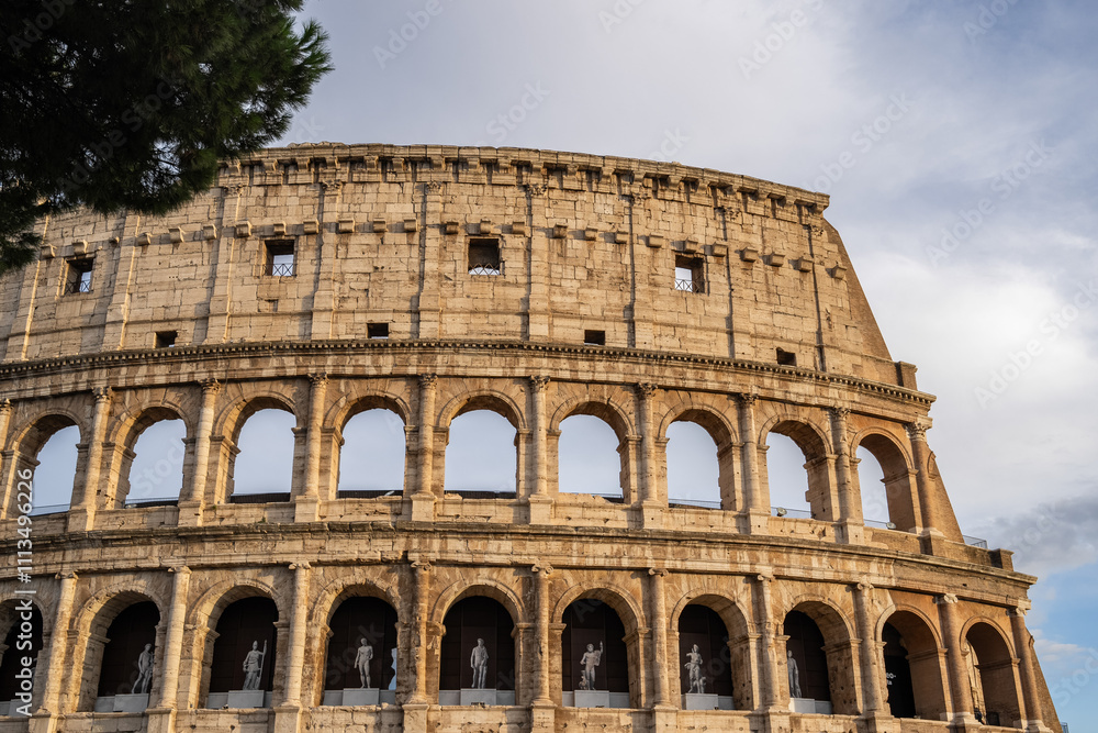 Obraz premium Arches archictecture of Colosseum (Colosseo) exterior with clouds and sky. Rome, Italy.