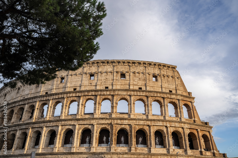 Obraz premium Arches archictecture of Colosseum (Colosseo) exterior with clouds and sky. Rome, Italy.