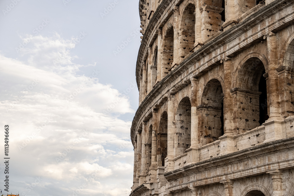 Obraz premium Arches archictecture of Colosseum (Colosseo) exterior with clouds and sky. Rome, Italy.
