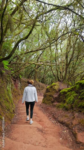 Wallpaper Mural Woman walking away on path through lush forest Torontodigital.ca