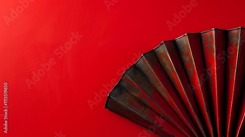 A concertina against a bright red surface photo