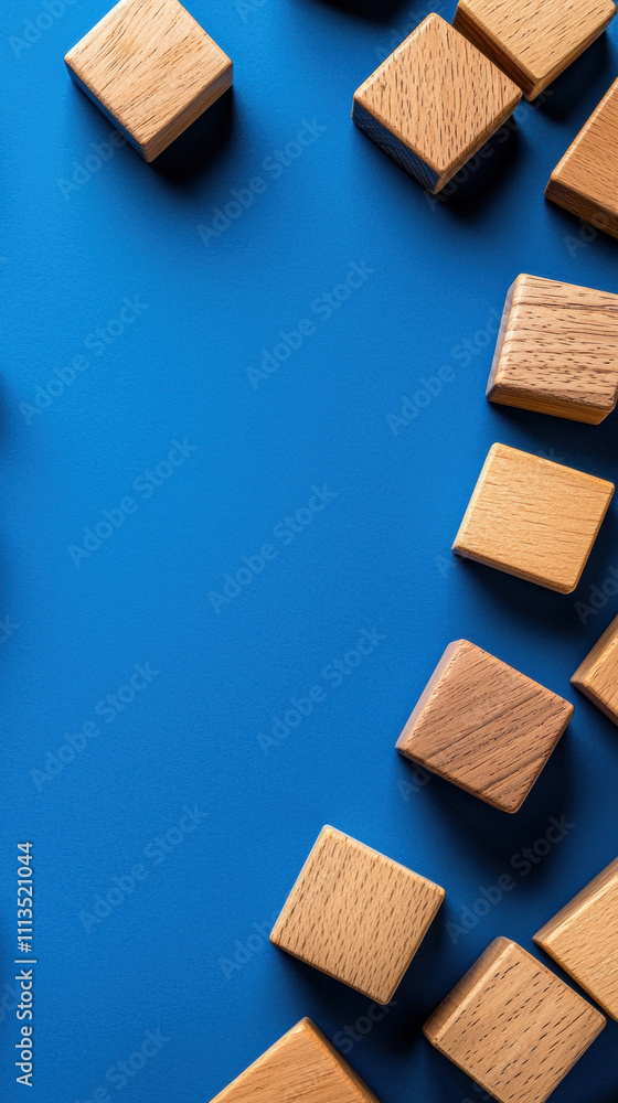 A vibrant blue background with wooden blocks scattered artistically, creating a playful and creative atmosphere. A vibrant blue background with wooden blocks scattered artistically, creating a playful and creative atmosphere.