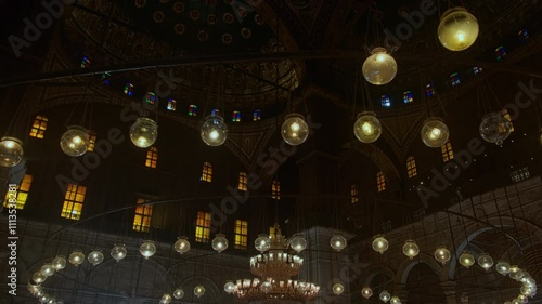 Chandelier and lanterns inside of The Great Mosque of Muhammad Ali Pasha or Alabaster Mosque. Low angle tilt view handheld footage. Islamic Cairo, UNESCO World Heritage site, Egypt