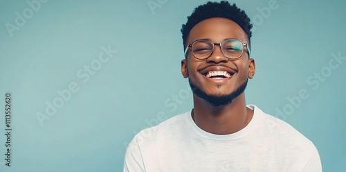 Young man smiles brightly against a colorful background in a casual setting