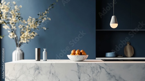 Sleek modern kitchen with marble countertop and bowl of oranges