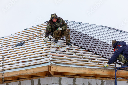 Wallpaper Mural Two men are working on a roof in the snow Torontodigital.ca