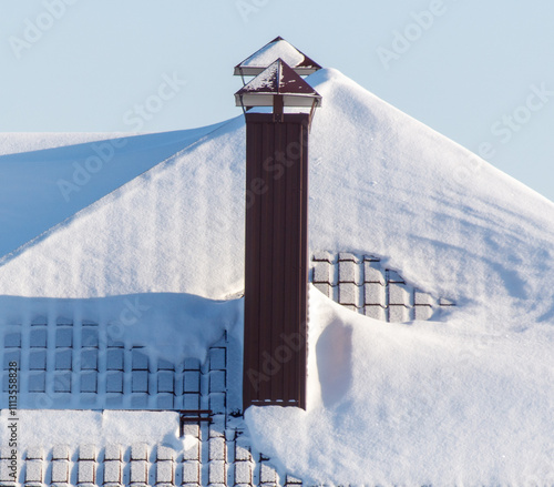 A chimney is covered in snow photo