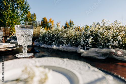 Fotografie Outdoor tablescape with place settings and baby's breath