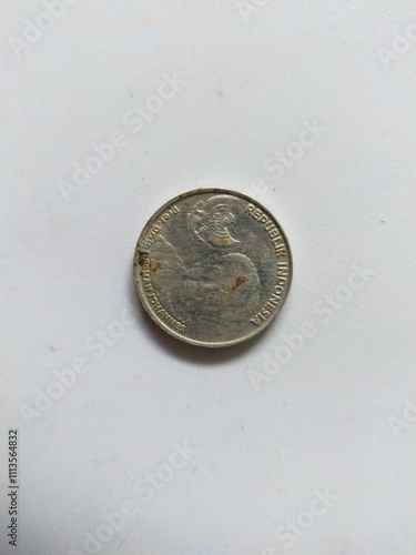 A close-up image of various coins scattered across a flat surface, showcasing different denominations and designs.