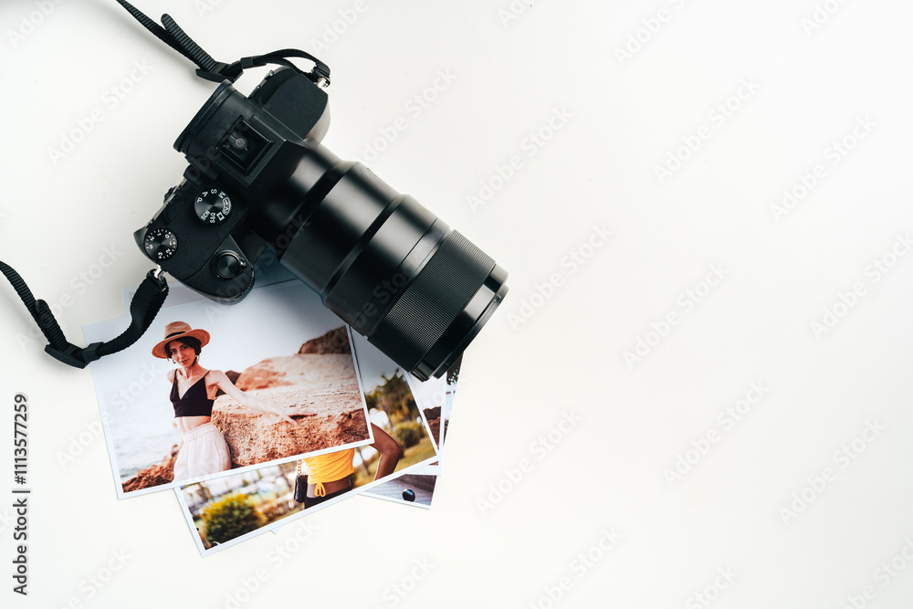 Camera and colorful printed photos of women on desk close up Camera and colorful printed photos of women on desk close up