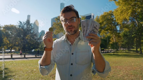 New world currency - dollar or bitcoin. Golden Bitcoin in man hand, businessman holding Digitall symbol of new virtual currency. male trader holds dolar cache and bitcoin cryptocurrency photo