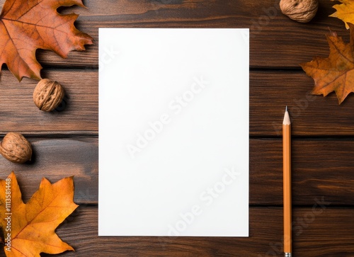Blank paper with autumn leaves and nuts on a wooden table, ready for ideas