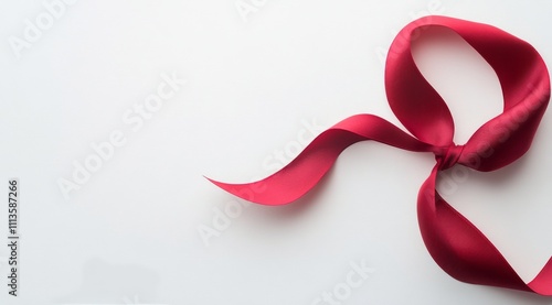 Elegant red ribbon displayed on a white background for gift wrapping or decor...