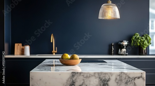 Sleek modern kitchen with marble countertop and bowl of oranges