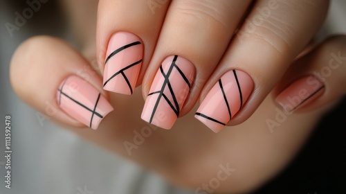 Stylish nail art with geometric design in soft orange tones on well groomed h...