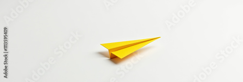 Yellow paper airplane against white background