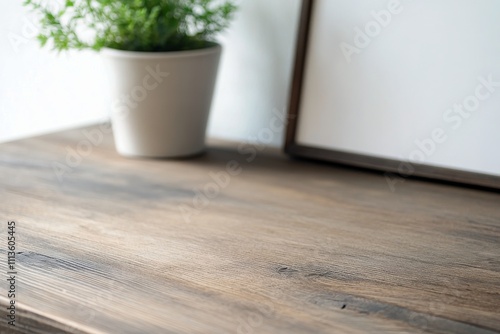 Elegant decorative display with a wooden panel and a vase on a rustic surface