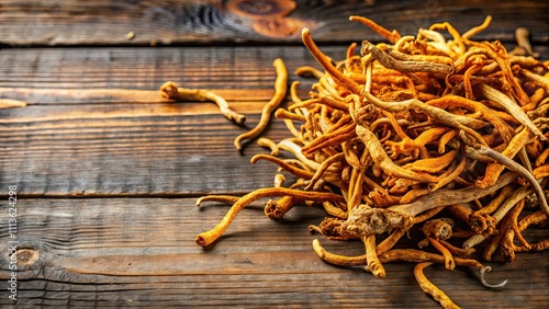 Dried cordyceps militaris on rustic wooden background , chong cao photo