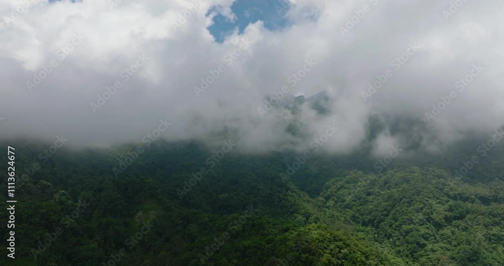 Mountain landscape: Mountain slopes covered with rainforest and jungle in Camiguin Island. Philippines. Mountain landscape: Mountain slopes covered with rainforest and jungle in Camiguin Island. Philippines.
