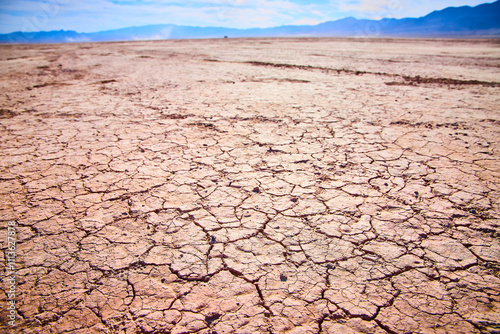 Photography Cracked Desert Landscape with Distant Mountains Low Angle View