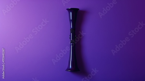 A kazoo positioned on a rich purple backdrop photo