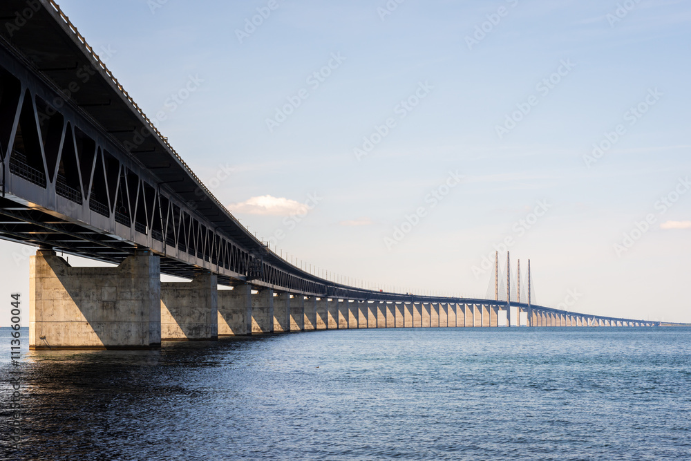 The Oresund bridge, seen from the swedish shore, is a railway and motorway cable-stayed bridge across the Oresund strait between Denmark and Sweden, opened to traffic in 2000. The Oresund bridge, seen from the swedish shore, is a railway and motorway cable-stayed bridge across the Oresund strait between Denmark and Sweden, opened to traffic in 2000.