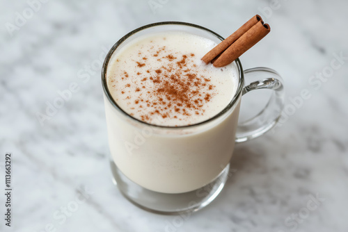 creamy eggnog in a clear mug, topped with cinnamon, perfect for festive celebrations and holiday gatherings