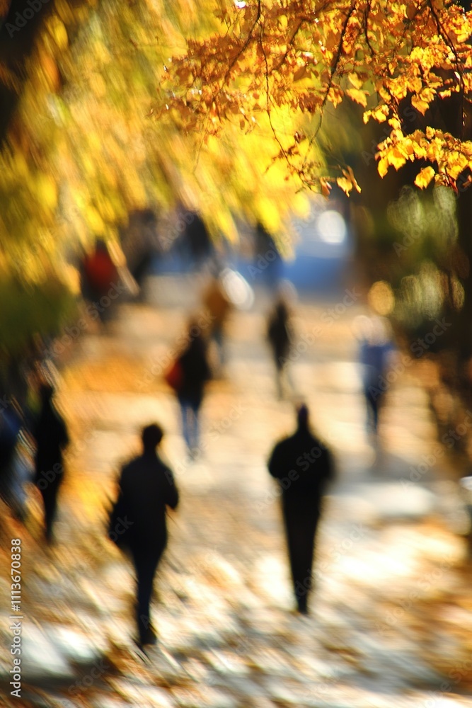Blurry image of people walking in autumn ambiance with golden leaves. Blurry image of people walking in autumn ambiance with golden leaves.