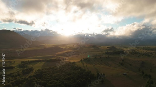 Aerial over farmland at sunset