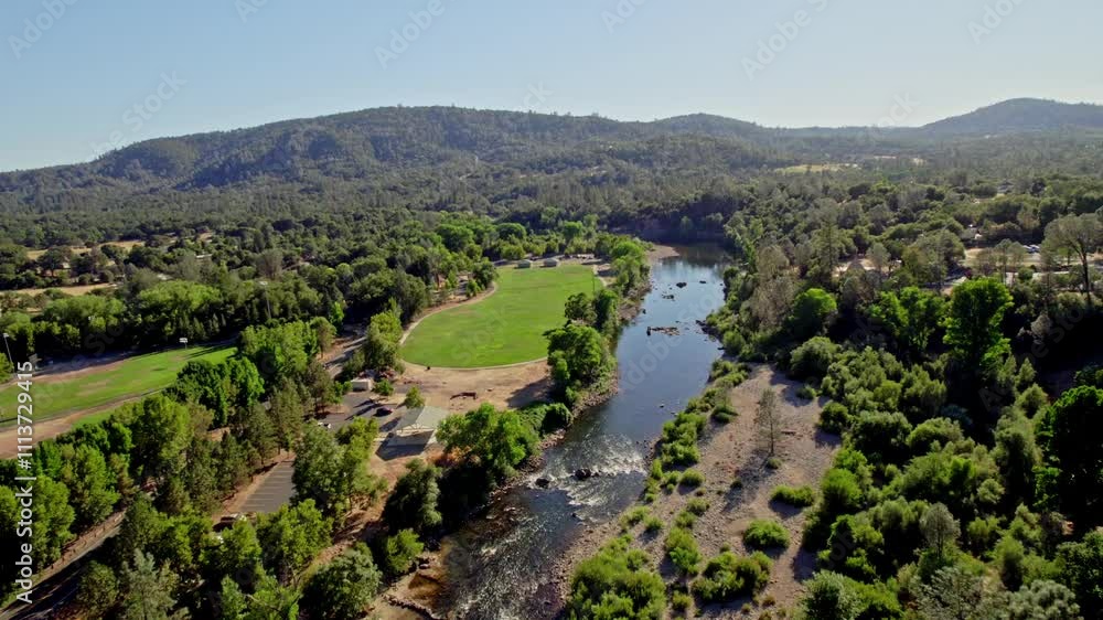 Stunning aerial view of serene river winding through lush green landscape Stunning aerial view of serene river winding through lush green landscape
