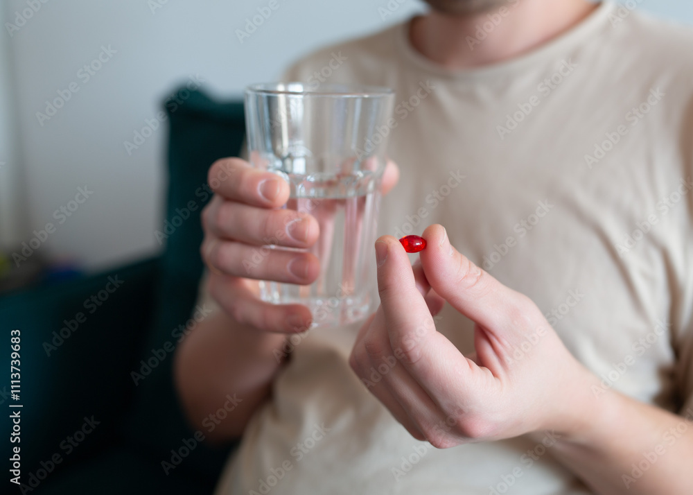 Man with tablet and glass of water, close-up Man with tablet and glass of water, close-up